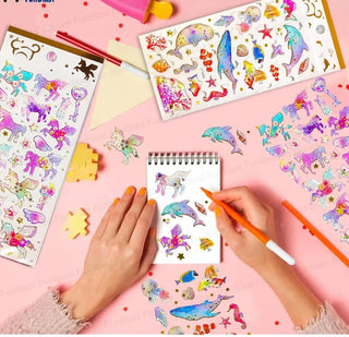 Kids using 3D puffy sticker sheets with unicorn and ocean animal designs on a notebook